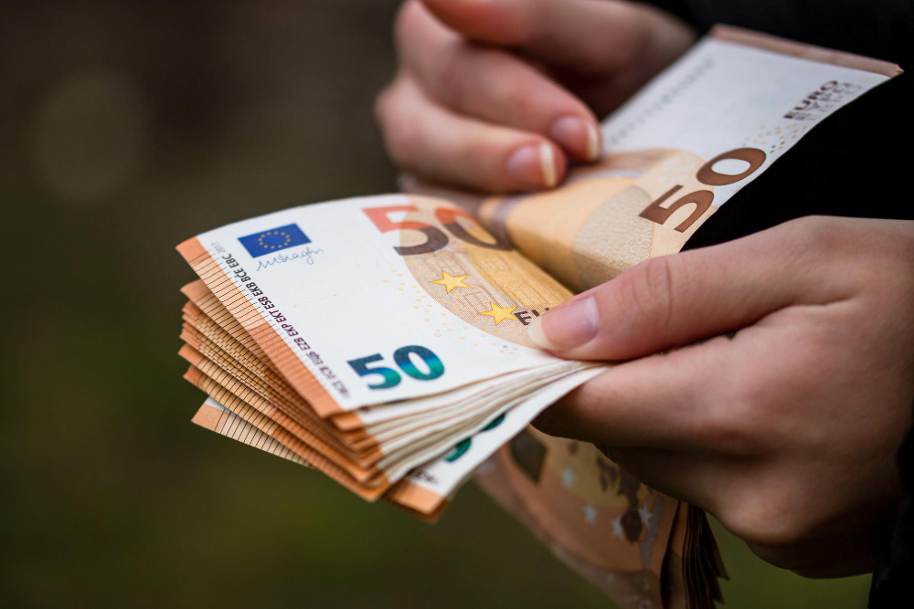 closeup-female-hands-counting-euro-banknotes-world-money-inflation-economy-concept