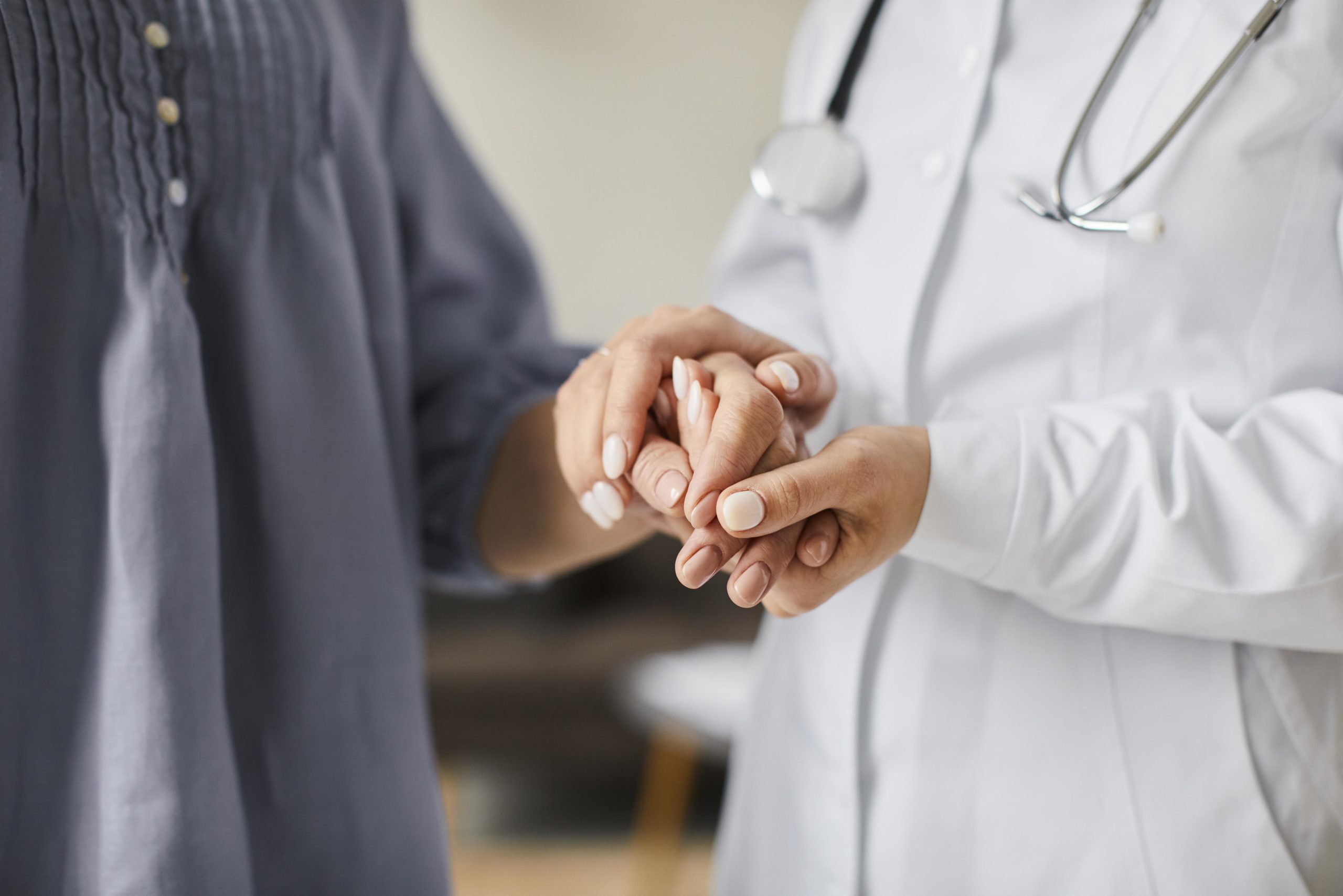 covid-recovery-center-female-doctor-holding-elderly-patient-s-hands-scaled