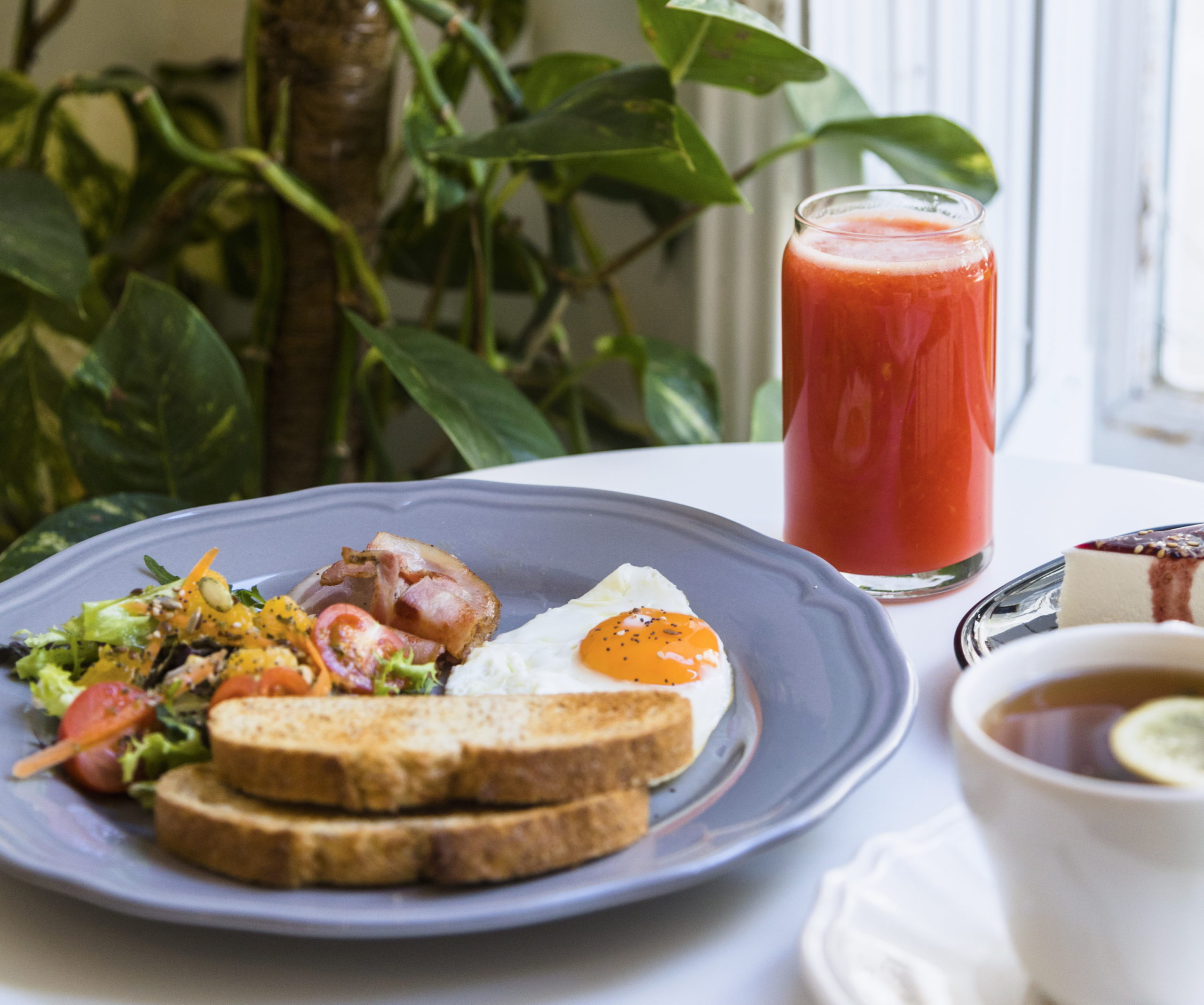 red-smoothie-breakfast-tea-white-table-near-epipremnum-aureum-plant-scaled
