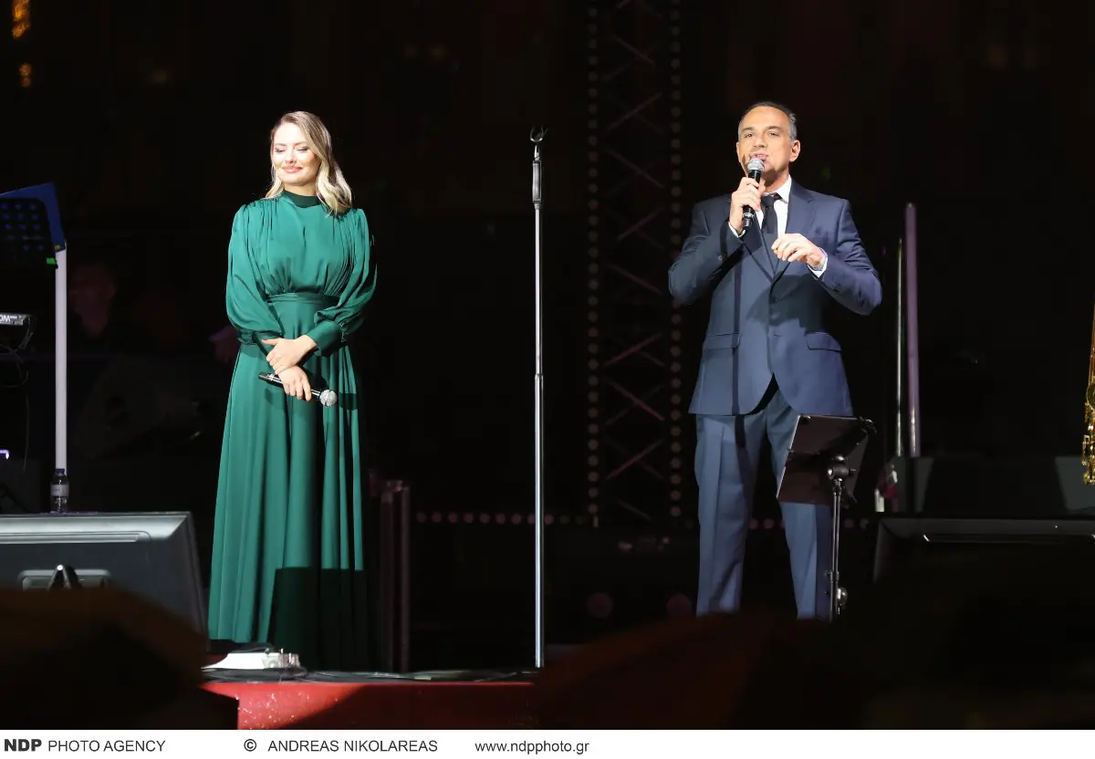 Σύνταγμα – Φωταγωγήθηκε το δέντρο με καταρρακτώδη βροχή και τον Μουζουράκη στη σκηνή 12 Ο Κρατερός Κατσούλης και η Ντόρα Μακρυγιάννη στη φωταγώγηση δέντρο του Συντάγματος