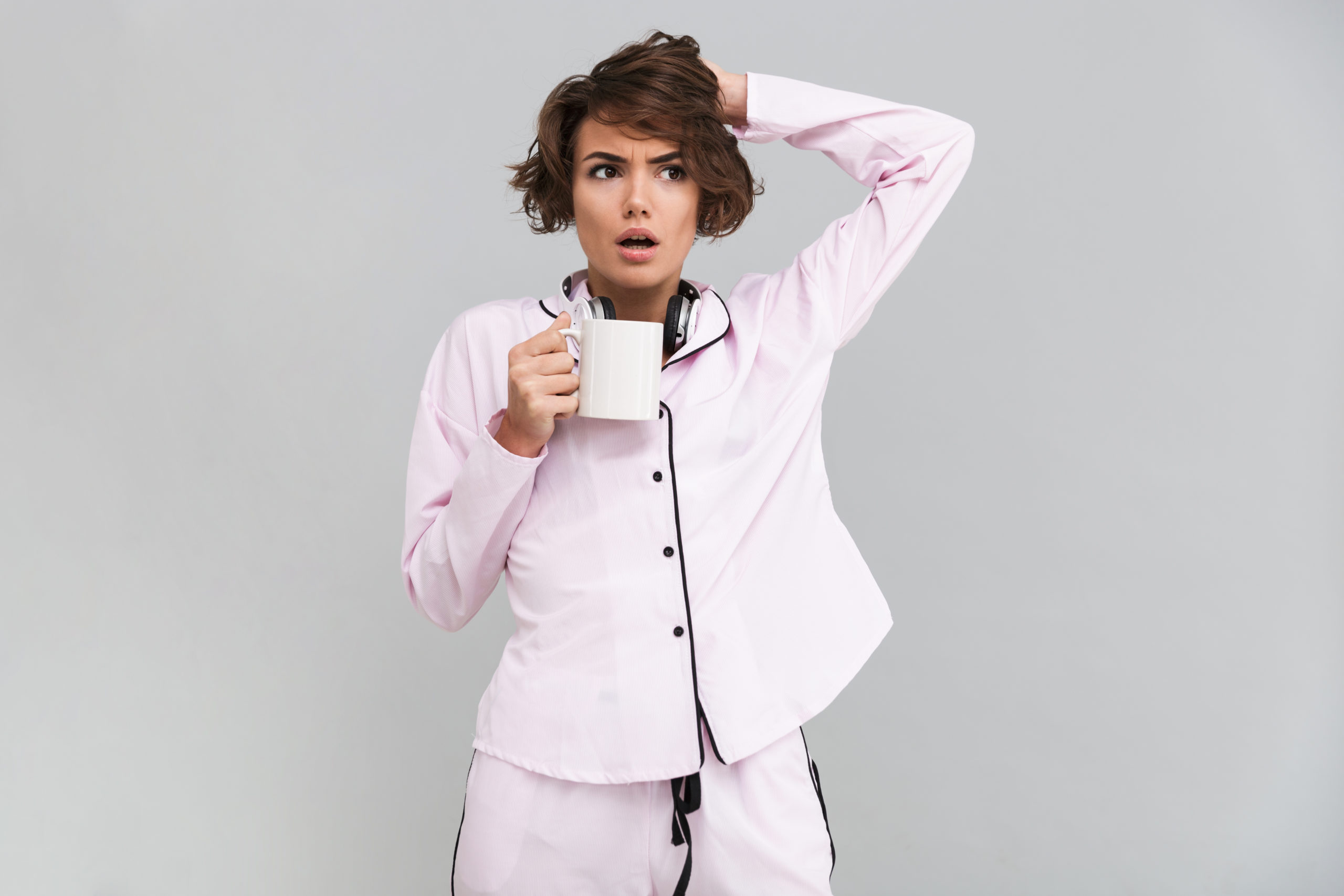 portrait-young-confused-woman-pajamas-wake-up-winter-scaled