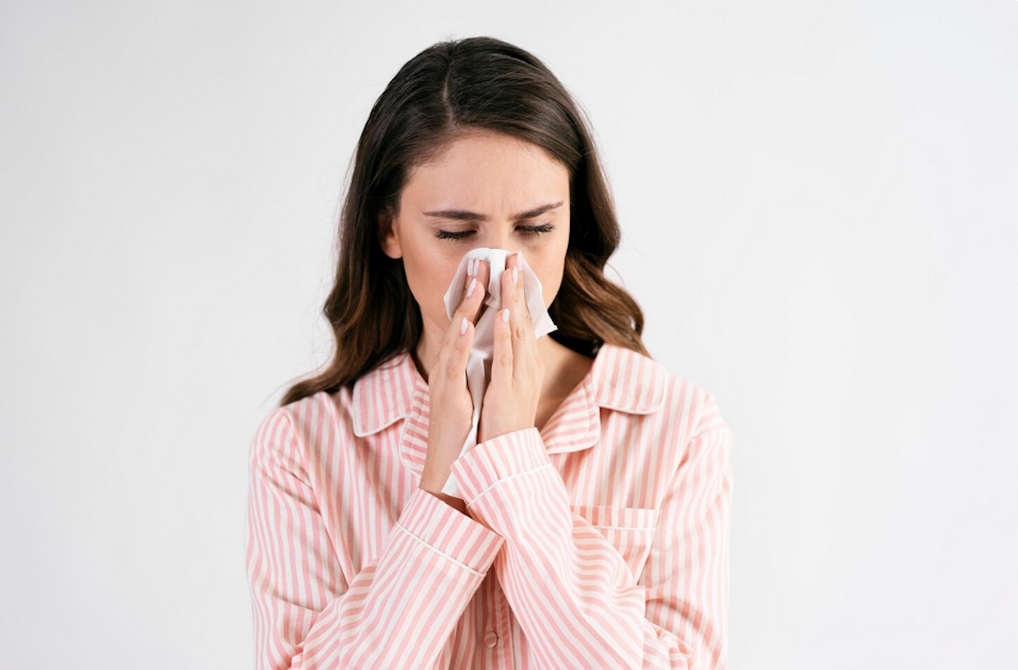 sick-young-woman-blowing-nose